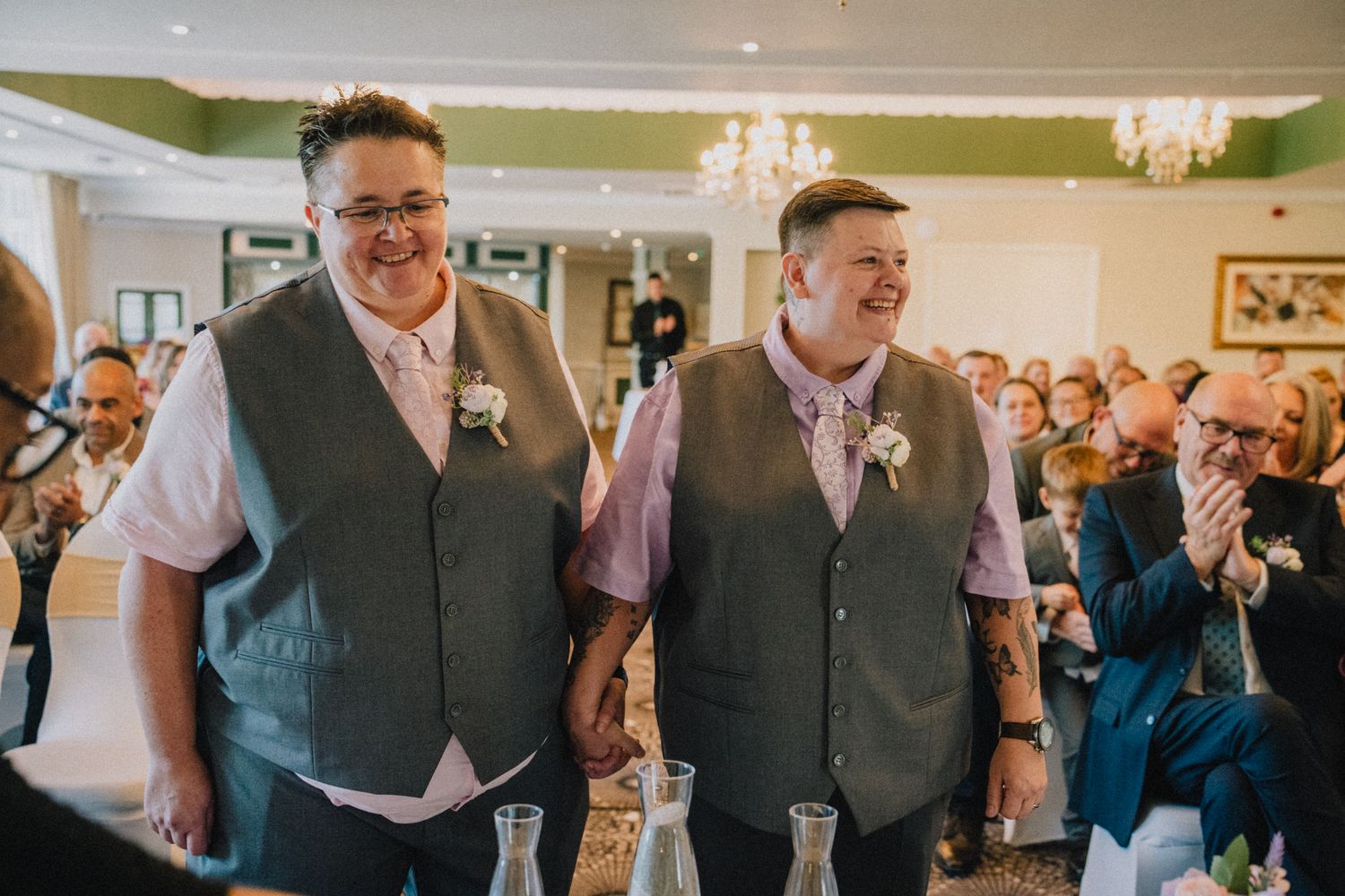 Lyn and Nic walking back down the aisle as married while guests applaud, Stone House Hotel wedding photographer Staffordshire