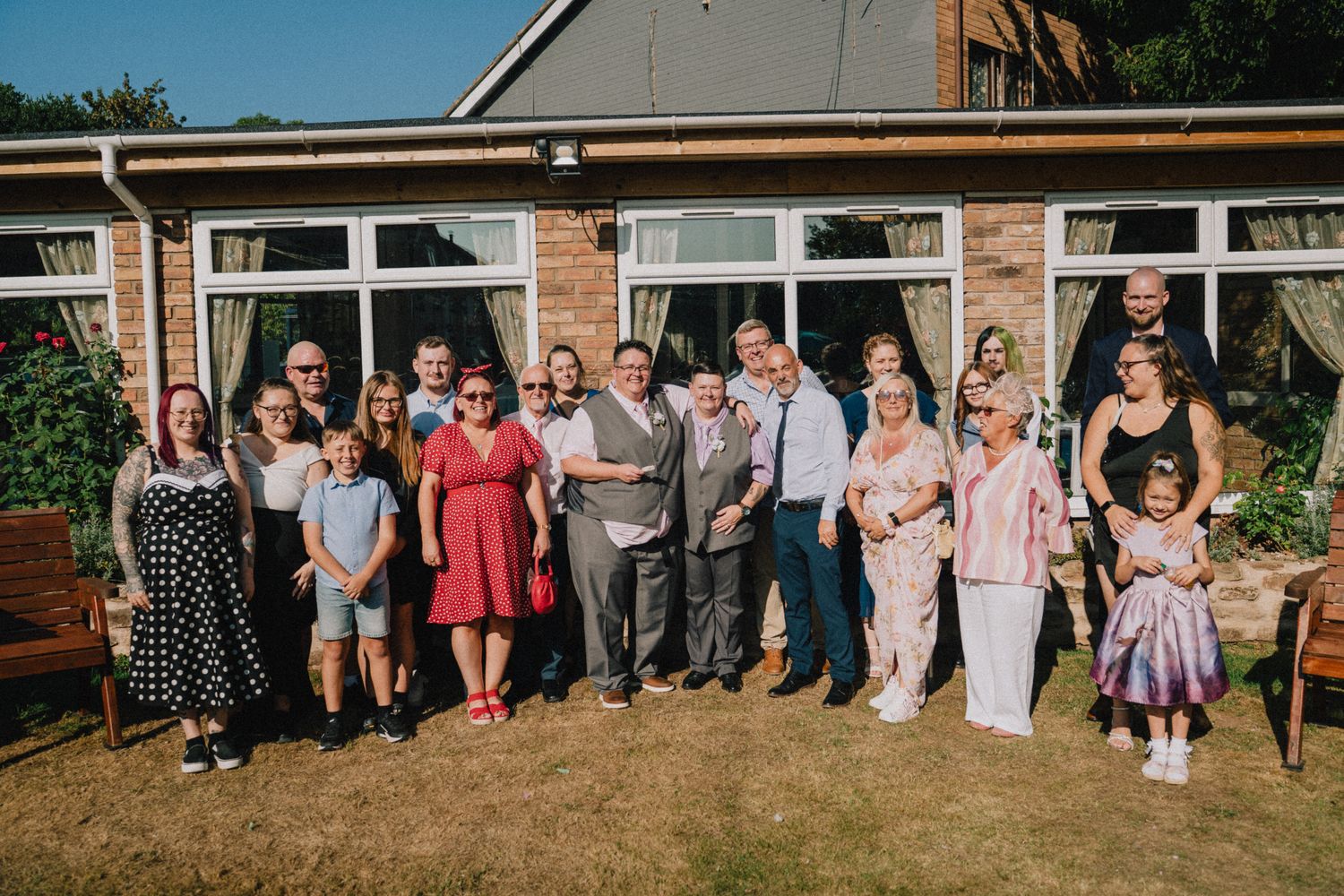 Large family group portrait with Lyn and Nic on the lawn behind the hotel, Stone House Hotel wedding photography Staffordshire