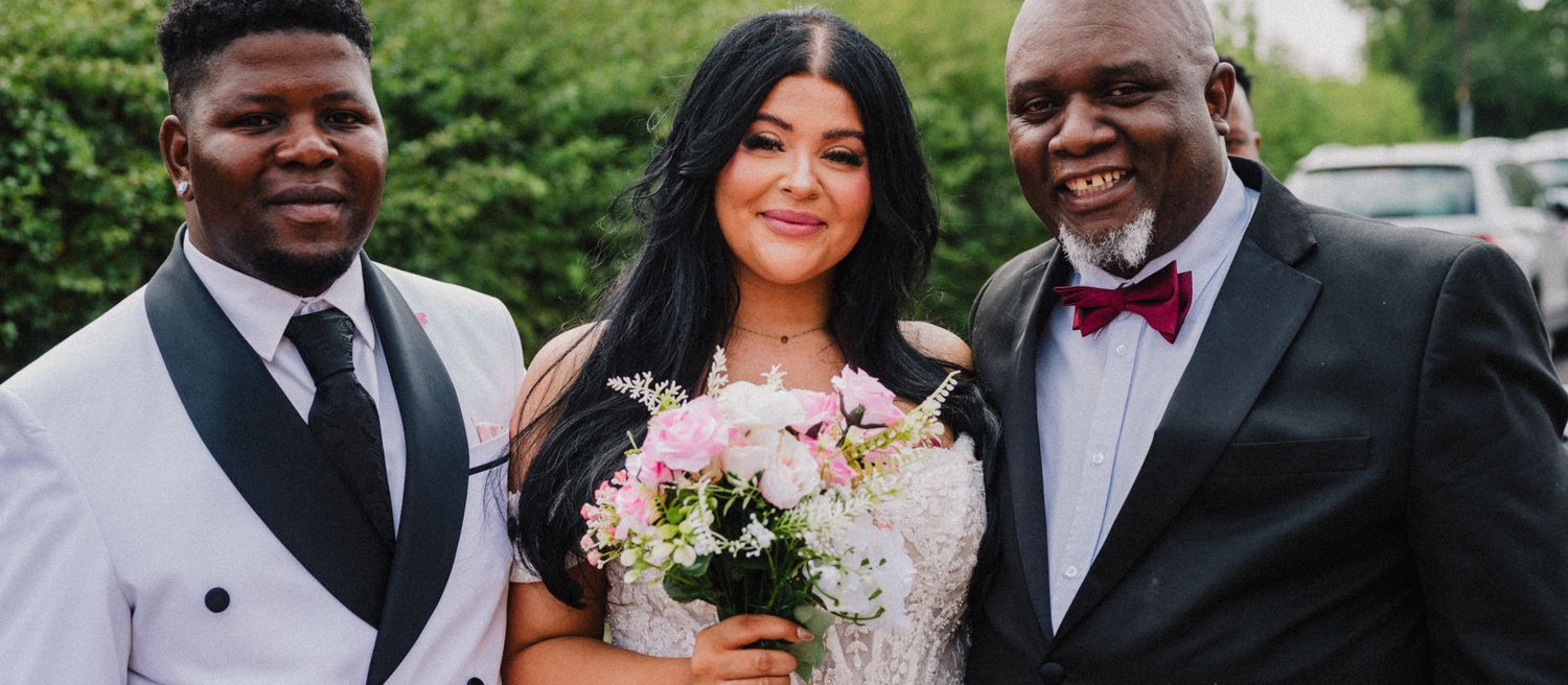 Family group portrait with the bride and groom outside Westbury Village Hall, Shropshire wedding photography